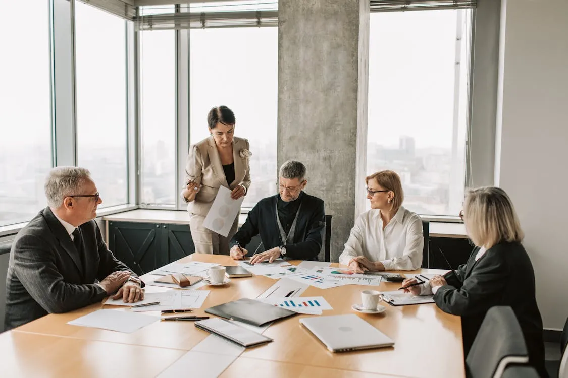 Business partners reviewing insurance documents in a meeting