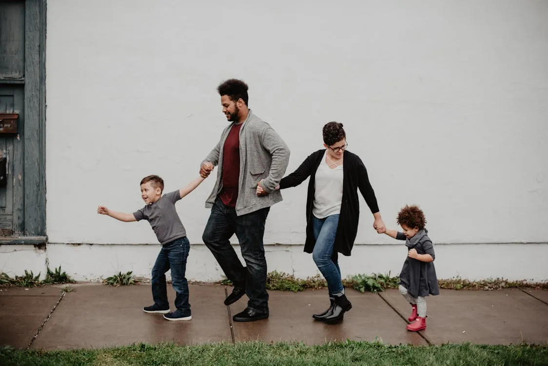 Family of four walking together — the reason life insurance matters
